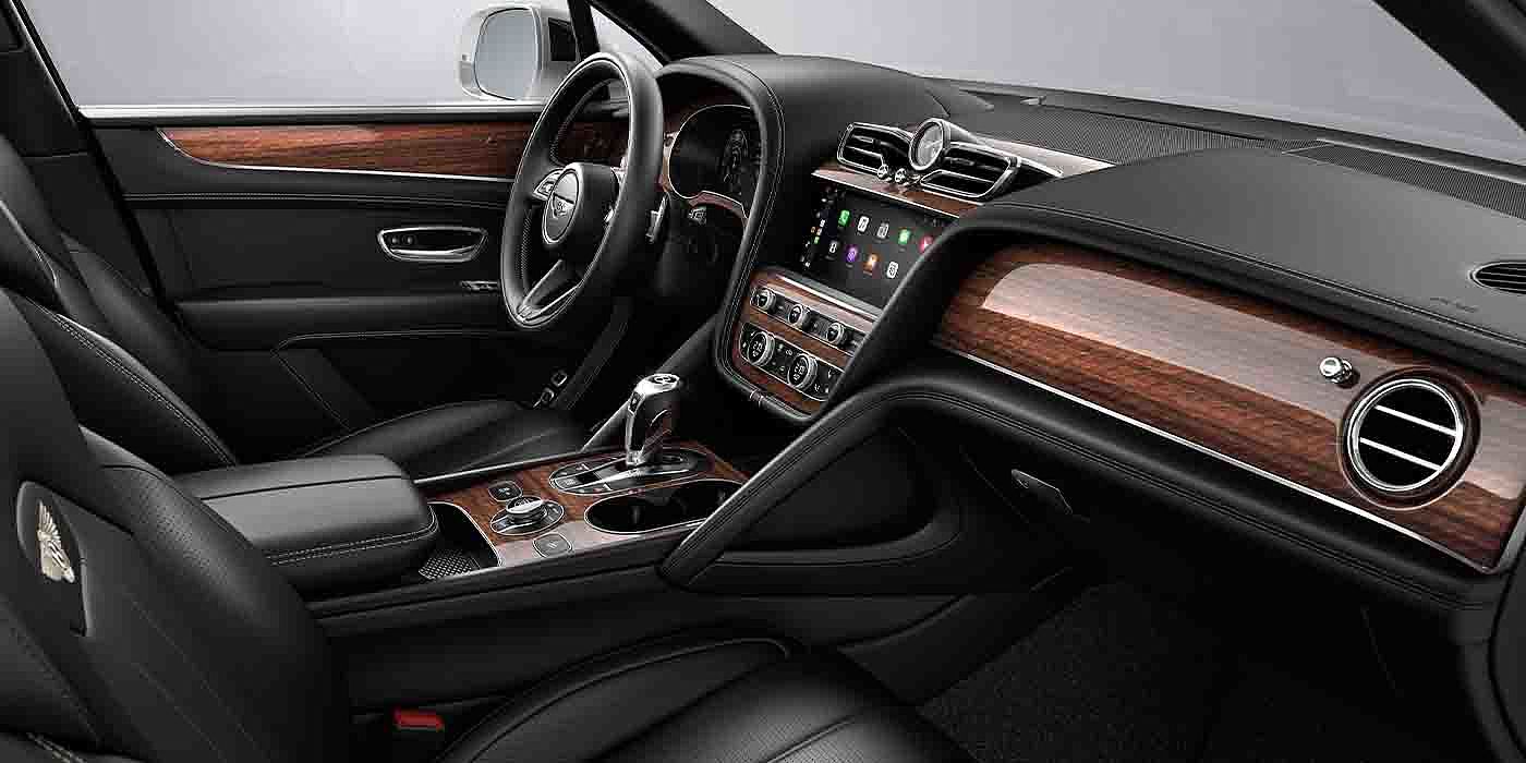 Bentley Fuzhou Bentley Bentayga EWB interior with a Crown Cut Walnut veneer, view from the passenger seat over looking the driver's seat.